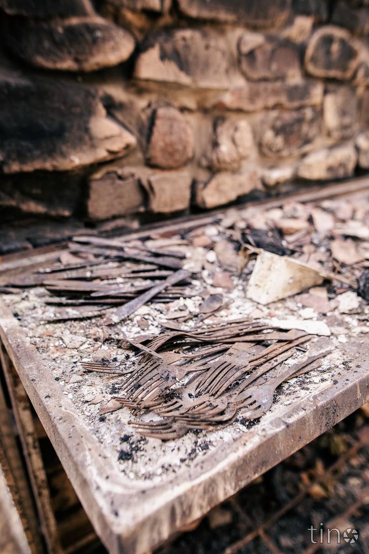 Burnt forks and spoons on a stone table