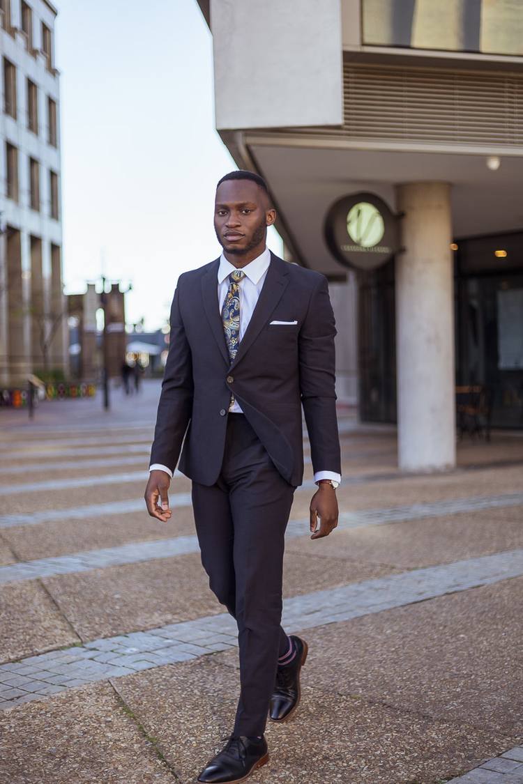 Man in a suit walking on a city street