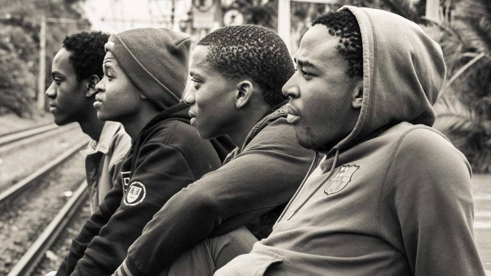 4 boys chilling by the train station.